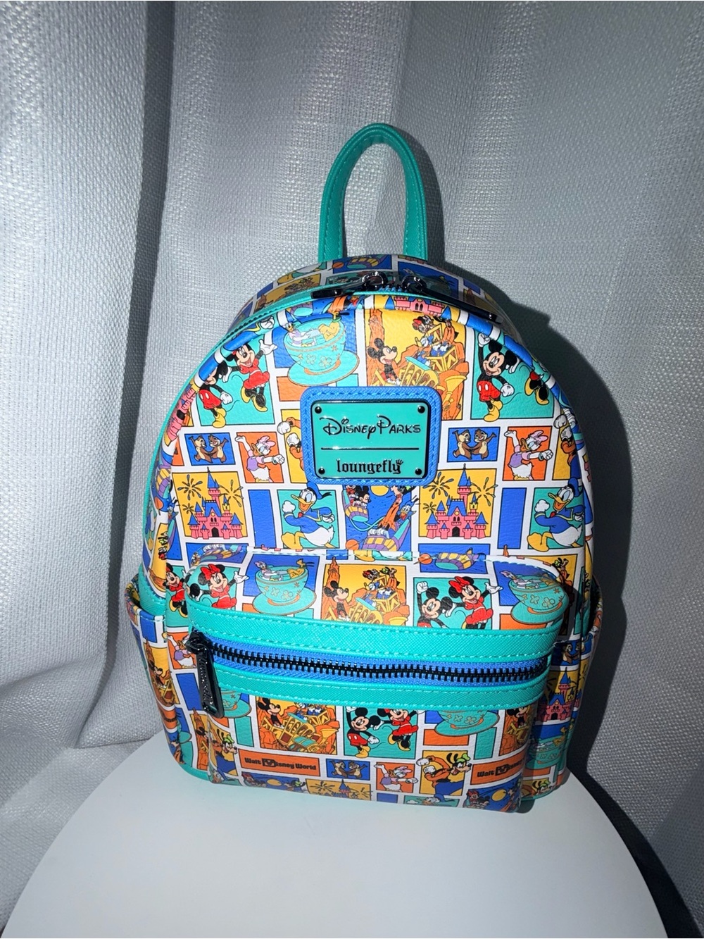 Loungefly Teal Disney Parks Mini Backpack with Multicolor Character Print